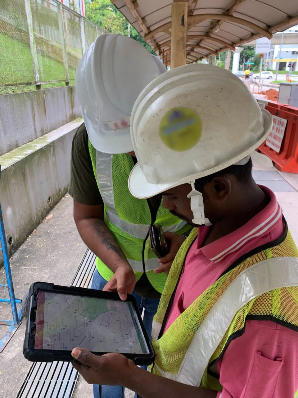 Site workers checking a site plan on a tablet
